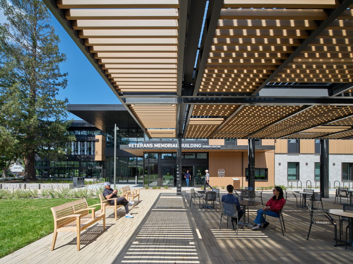 Pergola-covered courtyard with timber screening and community seating