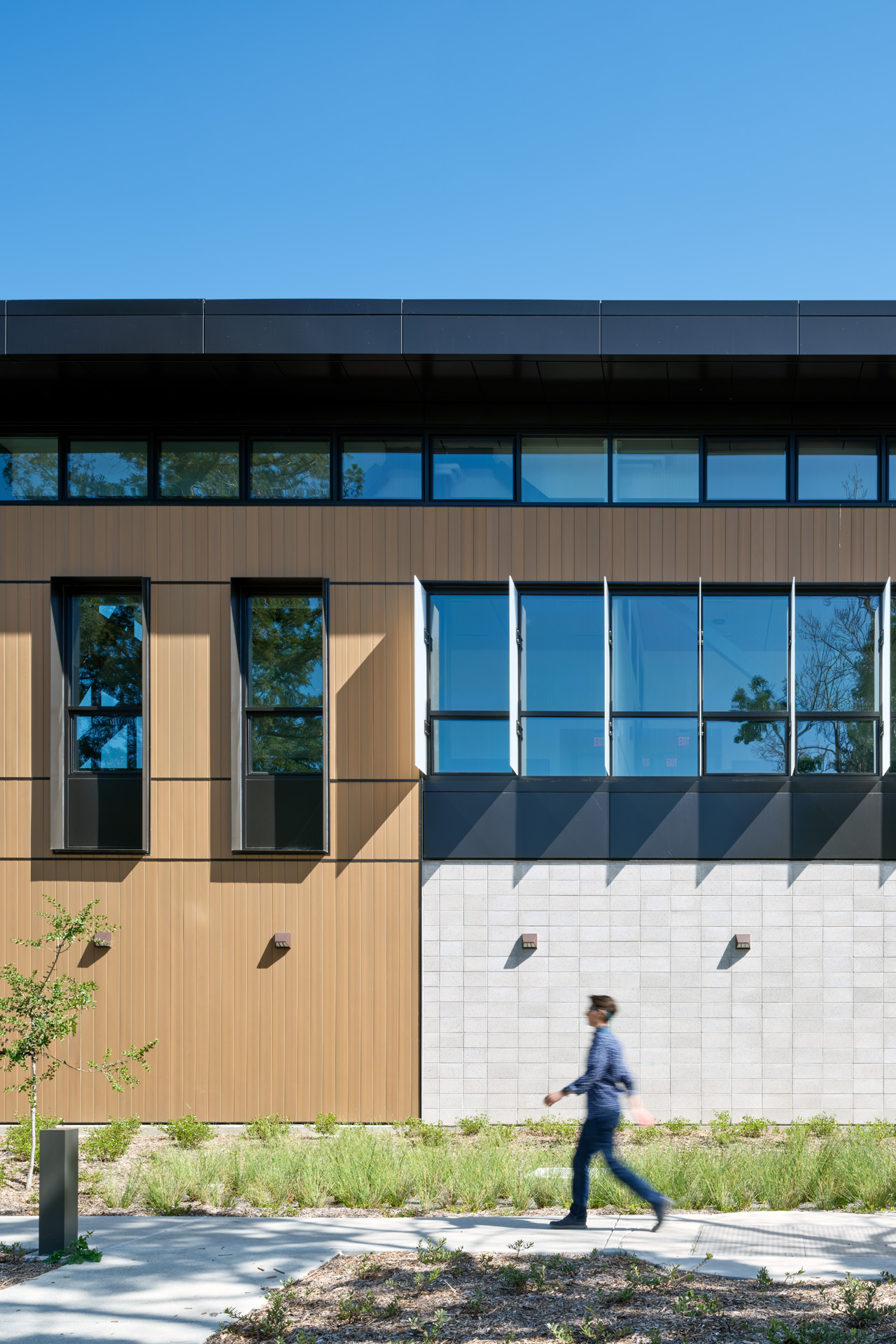 Close crop of INNOWOOD® V-Joint Shiplap Cladding, showing vertical joints and façade shadow lines